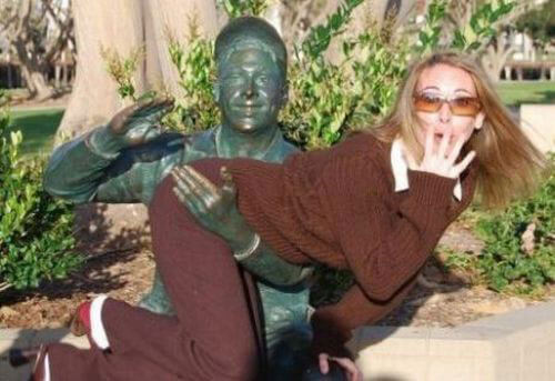 people having fun with statues 26